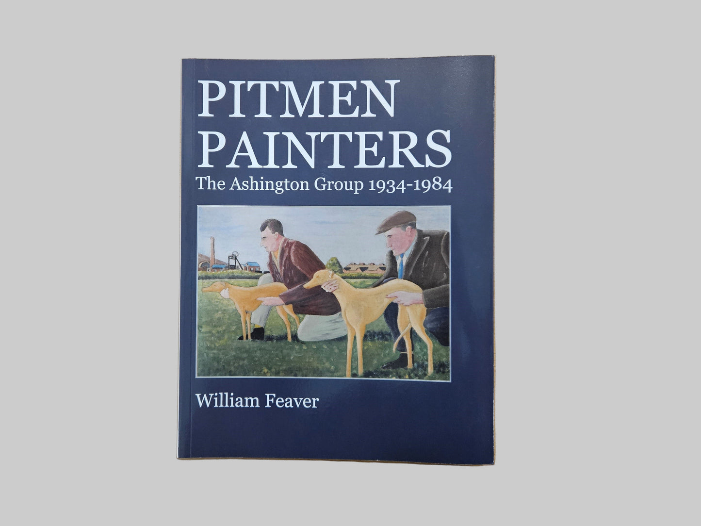 Book cover of 'Pitmen Painters' by William Feaver featuring two men with a whippet in a scene with a colliery in the back ground.