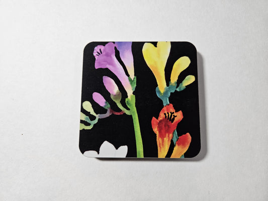 Colorful floral design on a black background coaster