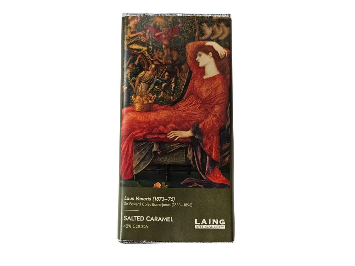 A boxed chocolate bar package standing upright on a light gray background. The front shows a dark illustration with a large red draped figure and the visible text 'LAING' and 'SALTED CARAMEL'.
