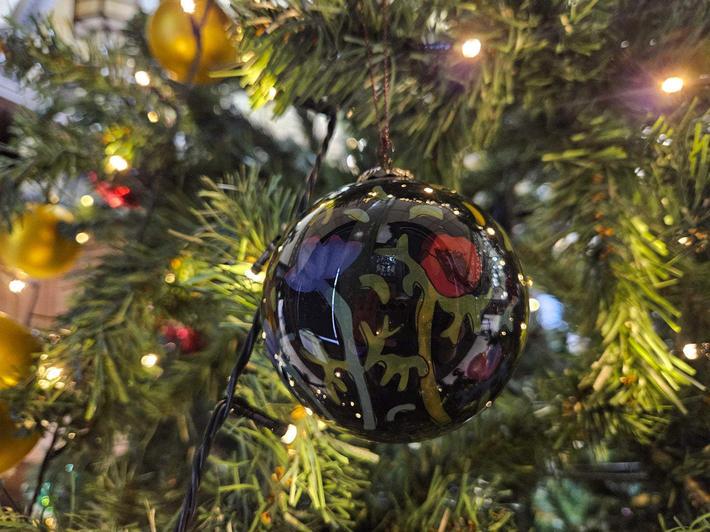 Decorative ornament with artistic design on a Christmas tree