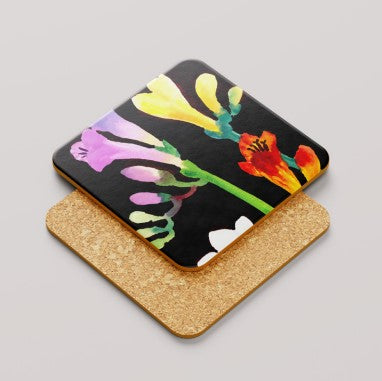 Cork coaster with colorful floral freesia design on a black background