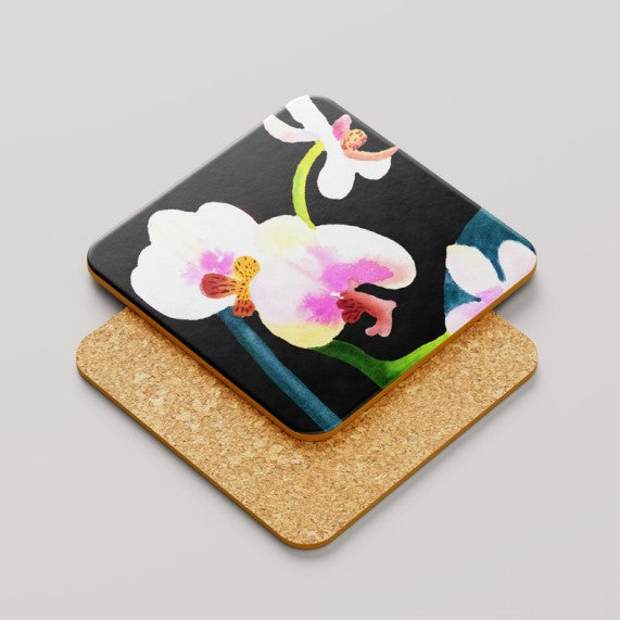 Coaster with floral orchid design on a black background