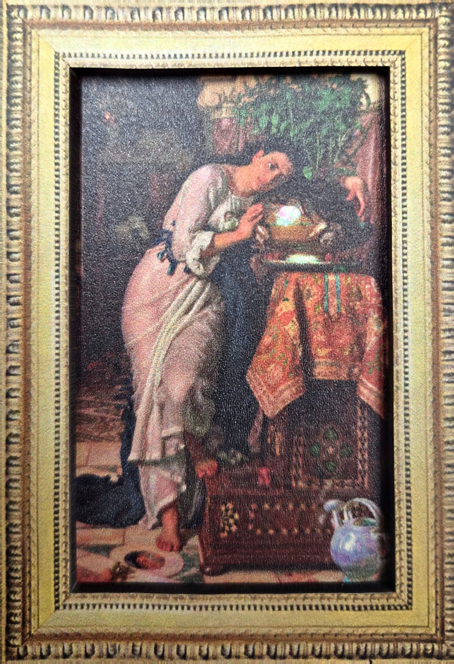 A magnet of the painting Isabella and the pot of basil with gold frame around. 