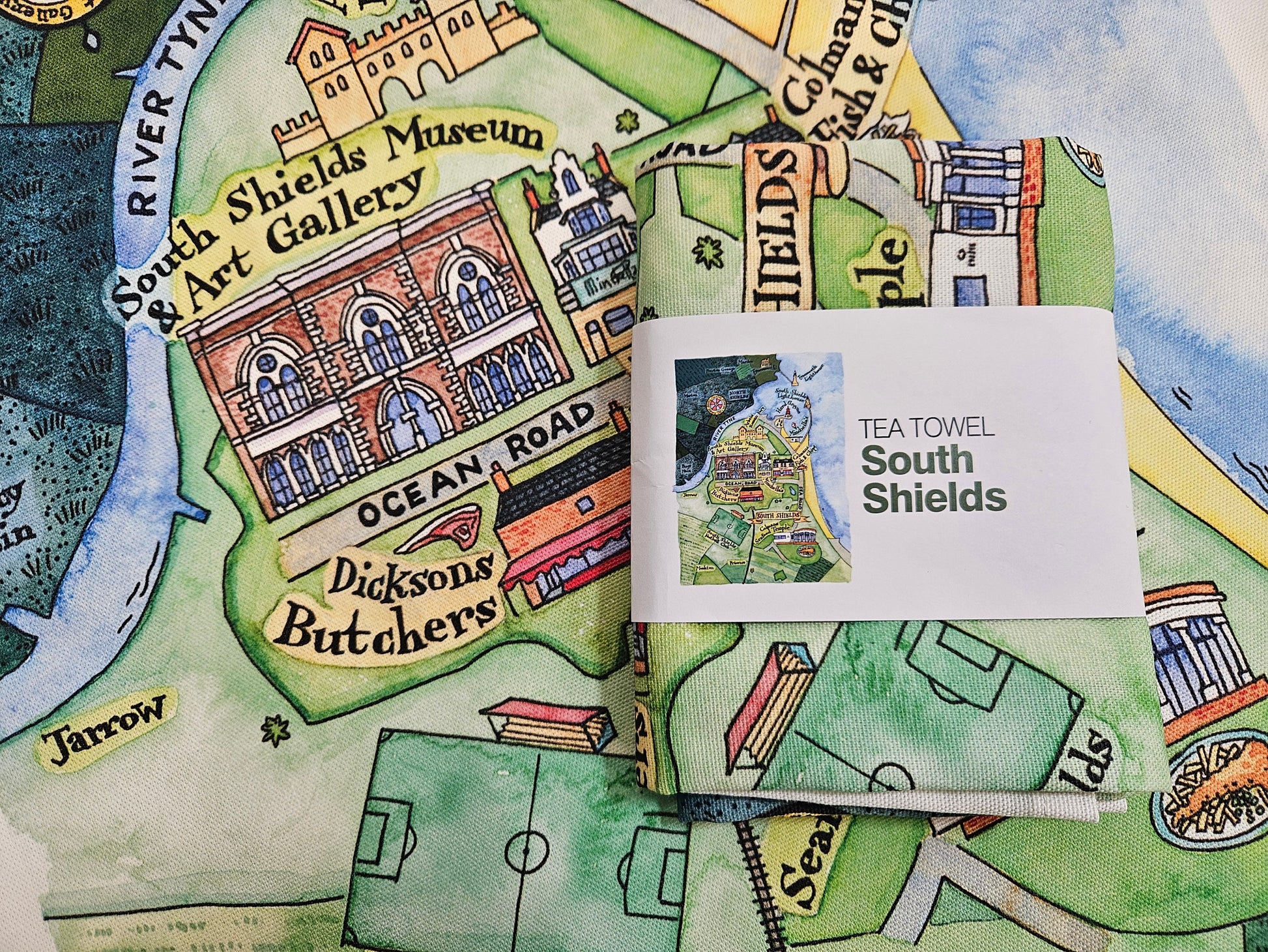 Tea towel with a map design featuring South Shields, England, and a small card labeled 'Tea Towel South Shields'.